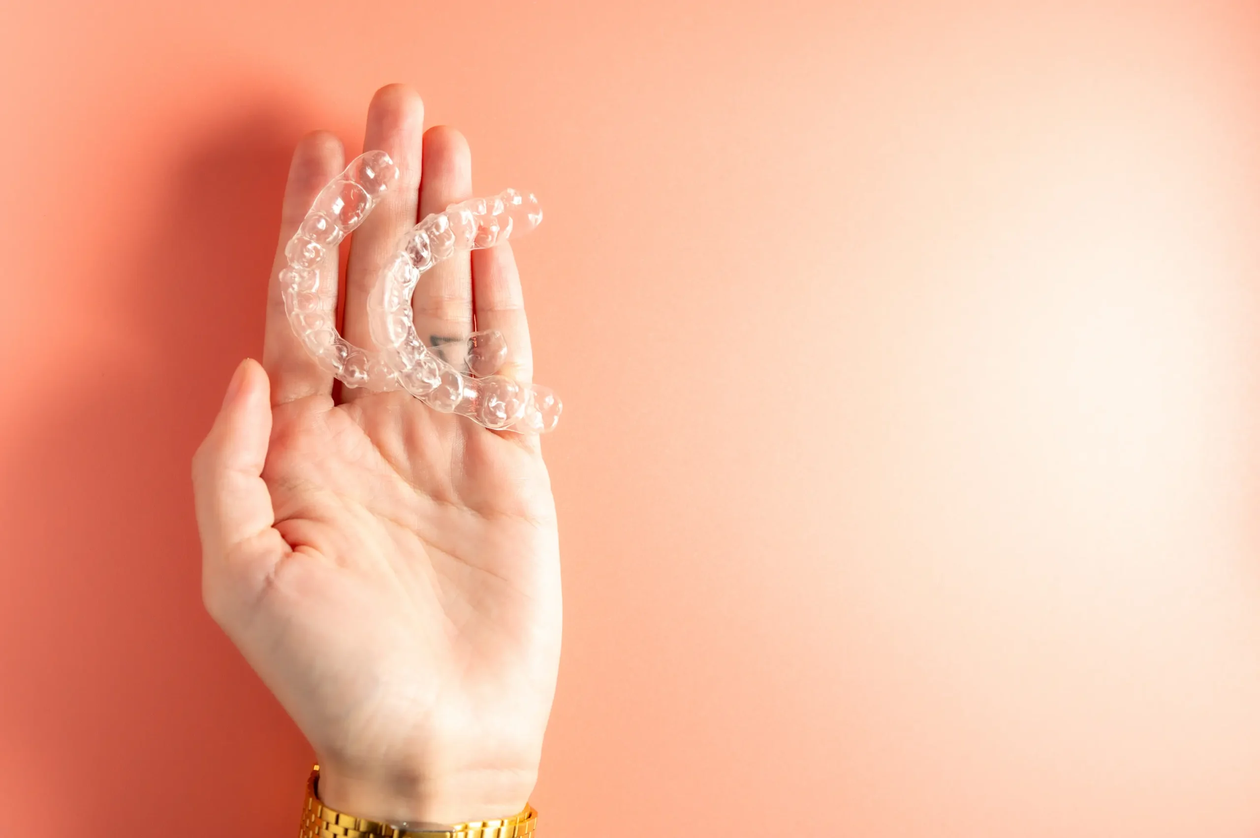 Hand holding a clear Invisalign aligner at Anzac Avenue Dental, Kallangur